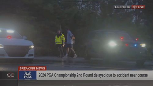 In this still image made from video provided by ESPN, Masters champions Scottie Scheffler is escorted by police after being handcuffed near Valhalla Golf Club, site of the PGA Championship golf tournament, early Friday, May 17, 2024. (ESPN via AP)