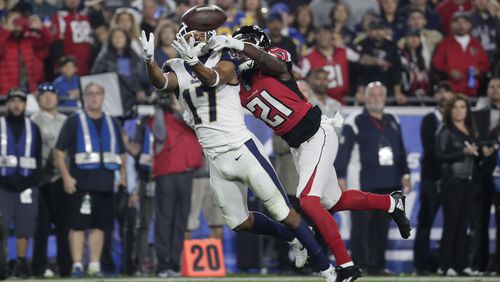 Despite Desmond Trufant's coverage, Los Angeles Rams wide receiver Robert Woods hauls in a long pass during the NFL wild card game in Los Angeles.  (Robert Gauthier/Los Angeles Times/TNS)