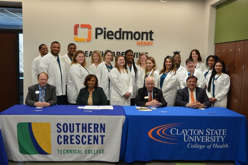 Clayton State University and Southern Crescent Technical College officials sign an agreement they hope will make it easier for Southern Crescent graduates to seek degrees from Clayton State. 