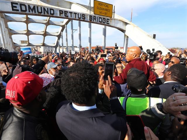 March 1, 2020 Selma: A group of men hoist U.S. Rep. John Lewis, D-Atlanta, on their shoulders so he can speak to the crowd of marchers at the Edmund Pettus Bridge during Selma's re-enactment of Bloody Sunday on Sunday, March 1, 2020, in Selma.  Curtis Compton ccompton@ajc.com