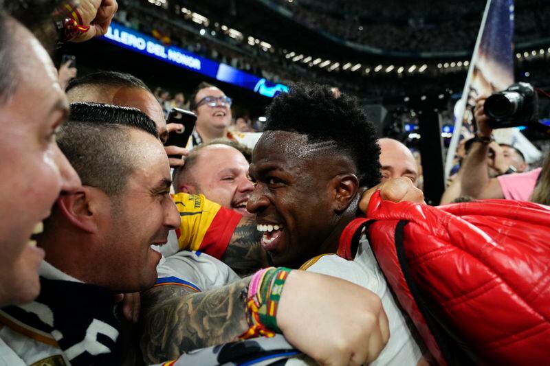 Real Madrid's Vinicius Junior celebrates with his supporters after winning the Champions League semifinal second leg soccer match between Real Madrid and Bayern Munich at the Santiago Bernabeu stadium in Madrid, Spain, Wednesday, May 8, 2024. Real Madrid won 2-1. (AP Photo/Jose Breton)