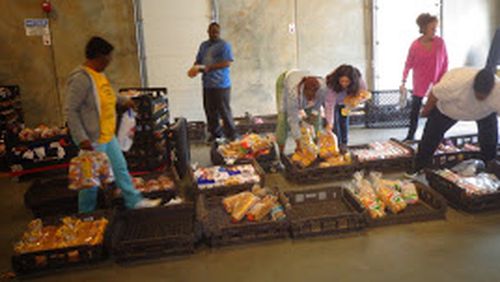 Volunteers help at the food pantry at Daily Bread for All. CONTRIBUTED