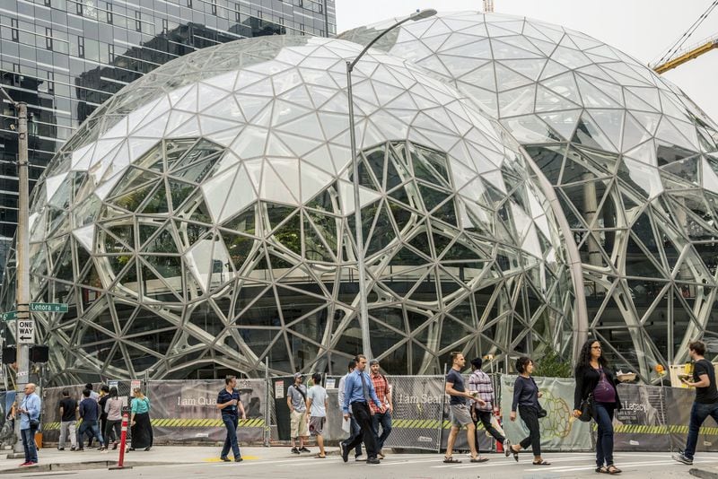 Pedestrians walk past a recently built trio of geodesic domes that are part of the Seattle headquarters for Amazon,. The online retail giant is searching for a second headquarters in North America, a huge new development that would cost as much as $5 billion to build and run, and house as many as 50,000 employees. (Stuart Isett/The New York Times)