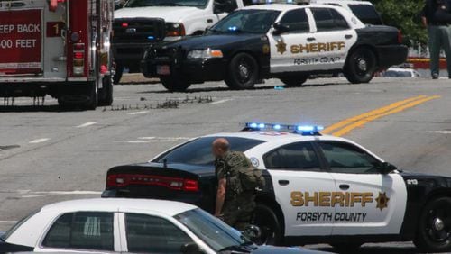 Forsyth County Sheriffs deputies, pictured here working an accident scene, conducted a recent sweep checking compliance by registered sex offenders. AJC file photo