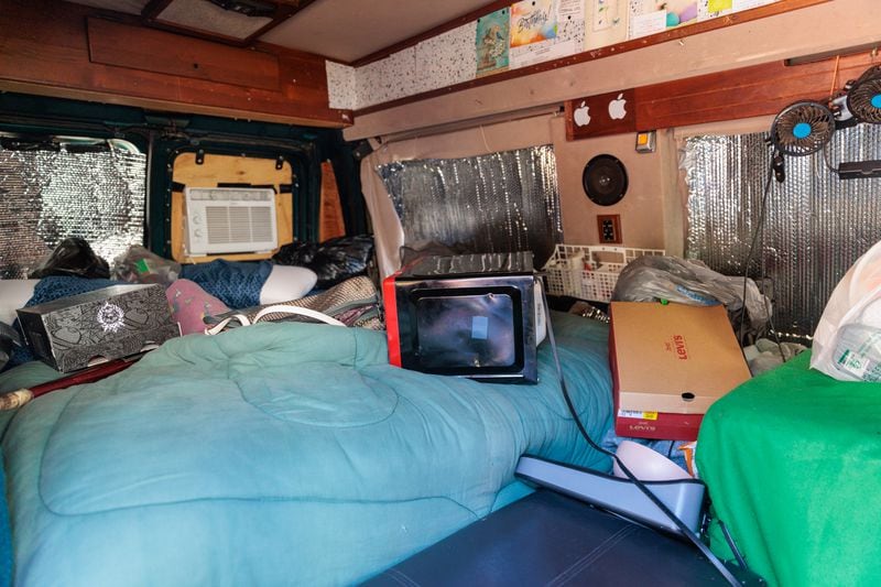 Synya Bradshaw, 52, and Maria Hairston, 35, lived in their van (pictured) before moving into their new apartment in Jonesboro on Thursday, November 3, 2022.   (Arvin Temkar / arvin.temkar@ajc.com)