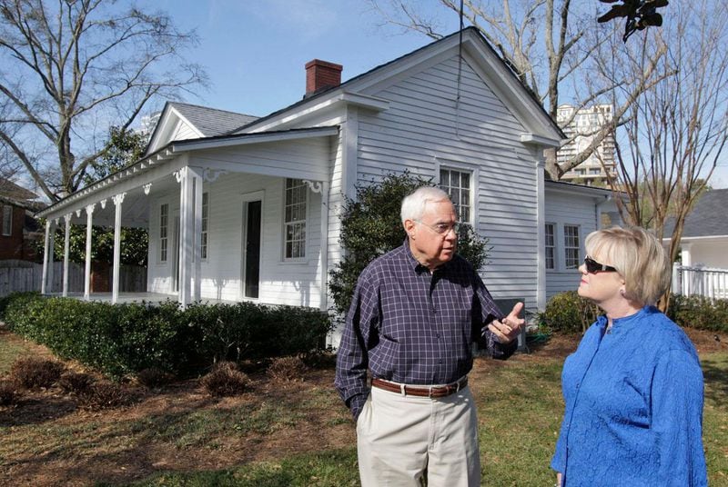 Cal Dortch and Gillian Greer, executive director of the Vinings Historic Society, stand in front of the Pace House on the site of the original home of Hardy Pace, one of the community’s founders.