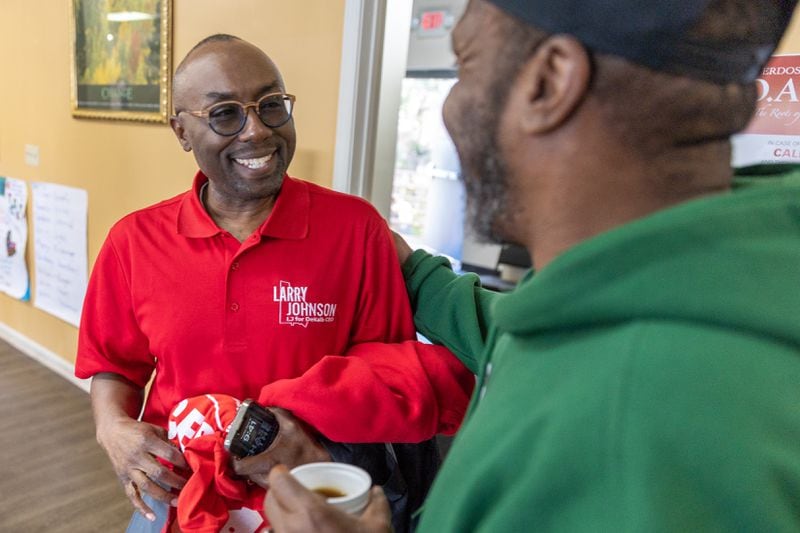 (L-R) Larry Johnson, a candidate for DeKalb CEO, is greeted by William Lesane while campaigning at The DOOR recovery center in Decatur on Tuesday, March 19, 2024. (Arvin Temkar / arvin.temkar@ajc.com)