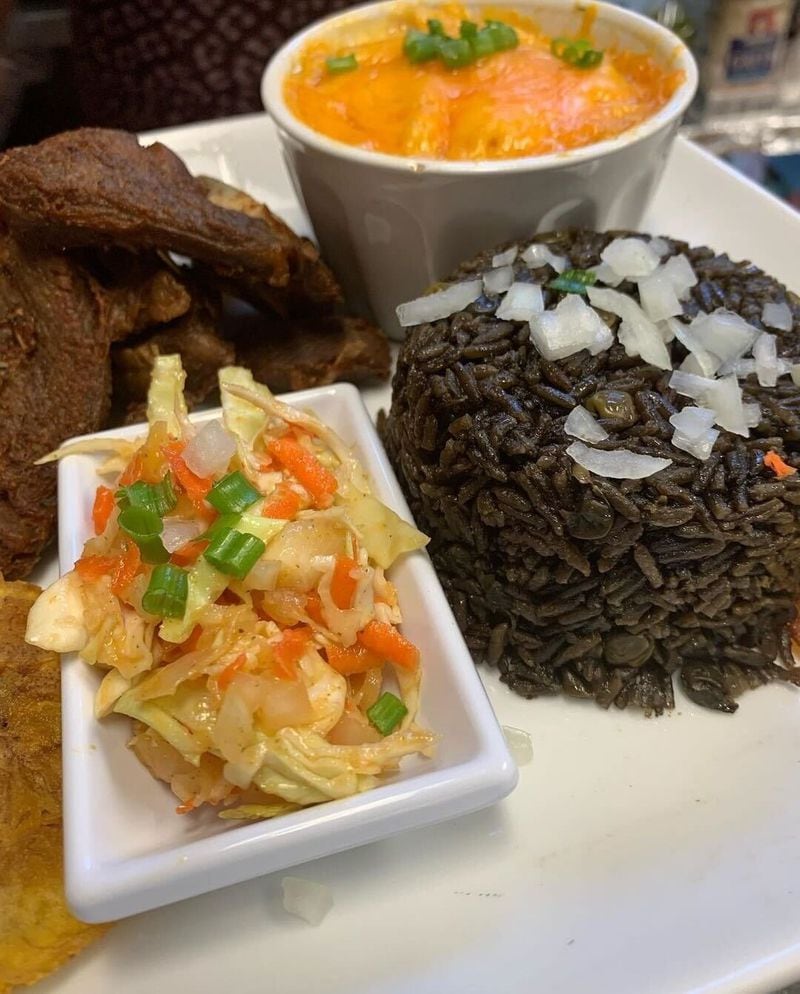 Goat with black rice and Haitian mac and cheese from the menu of ILounge in Marietta. (Courtesy of ILounge)