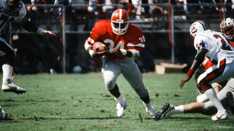 College Football Hall of Famer Herschel Walker said Georgia's offensive line made it easy for him to put up big numbers during the Bulldogs' run to the national championship in 1980. This photo would attest to that. (AJC file photo)