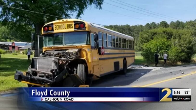 A woman faces four charges after allegedly hitting a school bus in Floyd County on Wednesday.