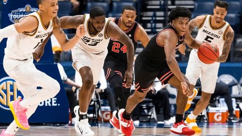 Georgia's Sahvir Wheeler (R, in black) breaks into the open court after coming up with his third steal late in the game. The 10th-seeded Bulldogs came back late on No. 7 Missouri but fell short 73-70 in the second round of the SEC Tournament at Bridgestone Arena in Nashville, Tenn. (Photo from UGA Athletics)