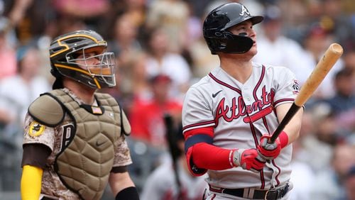 Braves' Joc Pederson (right) watches his solo home run as San Diego Padres catcher Victor Caratini looks on in the second inning Sunday, Sept. 26, 2021, in San Diego. (Derrick Tuskan/AP)