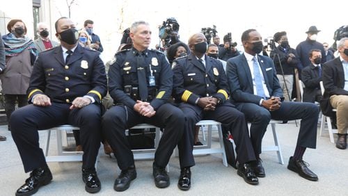 Atlanta police Deputy Chief Timothy D. Peek (far left), Zone 2 Commander Major Andrew Senzer, Chief Rodney Bryant, and Mayor Andre Dickens listen to remarks during the unveiling a new police precinct in Buckhead on Thursday, January 13, 2022. Miguel Martinez for The Atlanta Journal-Constitution
