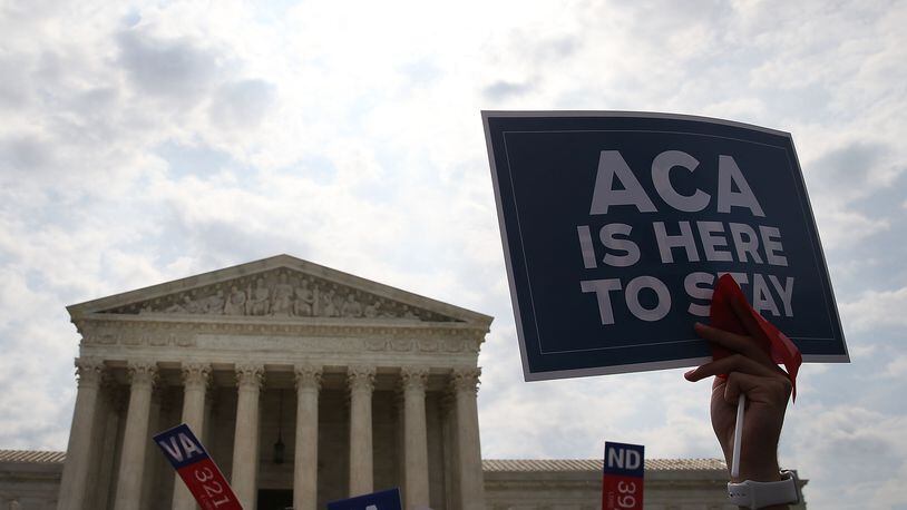 In this file image of the US Supreme Court building in 2016 a sign is held up that reads &quot;ACA Is Here To Stay&quot;after ruling was announced in favor of the Affordable Care Act. June 25, 2015 in Washington, DC. The Supreme Court refused Tuesday, January 21, 2020 to take up another challenge to the Affordable Care Act, leaving the health care law known as Obamacare intact.  (Mark Wilson/Getty Images)