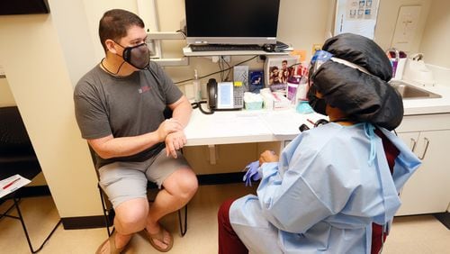 Yolanda Johnson, BSN RN, prepares Robert Gilleo for his monkeypox vaccination at the North Dekalb Health Center in Chamblee on August 5, 2022. Steve Schaefer / steve.schaefer@ajc.com)