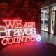 A neon sign reads the Atlanta Braves new marketing campaign, ‘We Are Braves Country,’ Tuesday, March 26, 2024, in Atlanta. (Jason Getz / jason.getz@ajc.com)