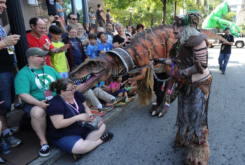 DRAGON CON PARADE--ATLANTA, GA: August 30, 2014 - A lady reacts to a dinosaur during the annual Dragon Con parade in downtown Atlanta. The parade featured 3200 Dragon Con fans dressed as their favorite characters from movies, television, comic books , literature and video games. An estimated 80,000 people watched the parade. Atlanta Journal - Constitution Special/ Johnny Crawford