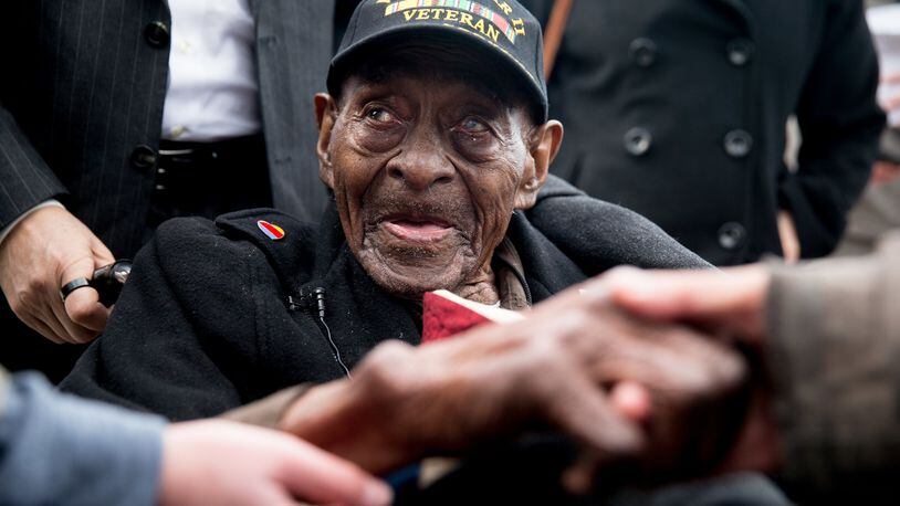 FILE - In this Dec. 7, 2015 file photo, Frank Levingston Jr., of Lake Charles, La., is greeted by visitors following a wreath laying ceremony to mark the anniversary of Pearl Harbor at the World War II Memorial in Washington. Levingston, a 110-year-old veteran who served in World War II has died, on Tuesday, May 3, 2016. (AP Photo/Andrew Harnik)