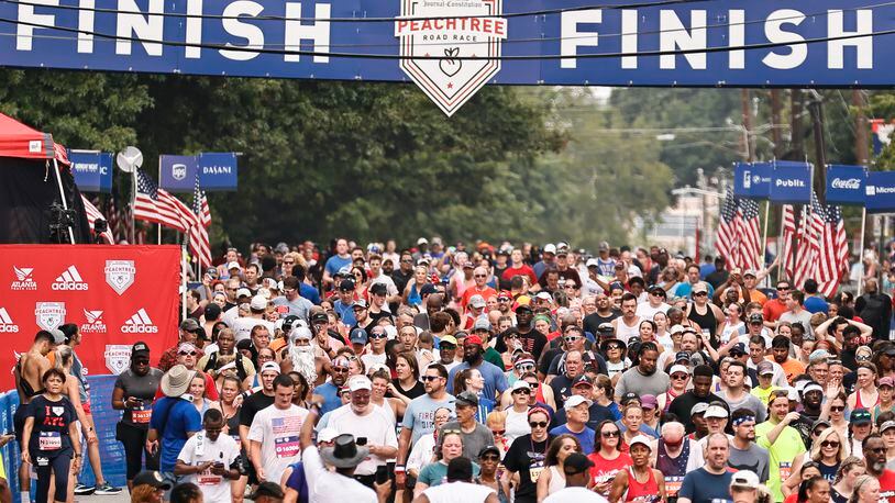 Hundreds of runners cross the finish line of the Atlanta Journal-Constitution Peachtree Road Race on Monday, July 4, 2022 (Natrice Miller/natrice.miller@ajc.com)