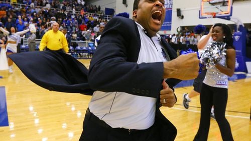 Georgia State coach Ron Hunter reacts to winning the Sun Belt men’s basketball regular-season championship charging the fans after beating Georgia Southern 72-55 in a basketball game on Saturday, March 7, 2015, in Atlanta. Curtis Compton / ccompton@ajc.com