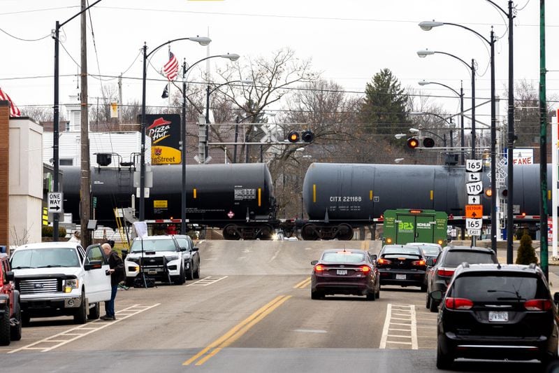 A train passes through East Palestine, Ohio, on Friday, Feb. 17, 2023. Thirty-eight cars of a Norfolk Southern train derailed Feb. 3 in the town. Five hazardous materials cars carrying vinyl chloride were among the cars that derailed. the vinyl chloride was later burned in a controlled burn. (Arvin Temkar / arvin.temkar@ajc.com)