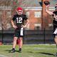 Georgia freshman quarterback Ryan Puglisi (12) looks as as senior starter Carson Beck (15) unleashes a pass during the Bulldogs' first spring practice session in Athens on Tuesday. (Tony Walsh/UGA Athletics)