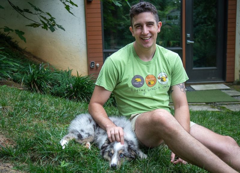  Charlie Levy poses for a photograph with his puppy Bodhi at his Atlanta Home August 3, 2020.  STEVE SCHAEFER FOR THE ATLANTA JOURNAL-CONSTITUTION