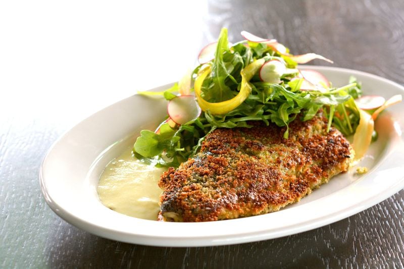 Crab Stuffed Trout for Two at City Pharmacy brings a Carolina trout covered in a golden potato crust with a lemon butter sauce and dressed arugula. CONTRIBUTED BY CITY PHARMACY
