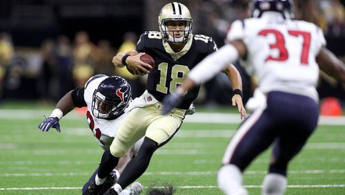 Garrett Grayson (18) of the New Orleans Saints avoids a tackle by  Bryce Jones of the Houston Texans at Mercedes-Benz Superdome on August 26, 2017 in New Orleans, Louisiana.  (Photo by Chris Graythen/Getty Images)