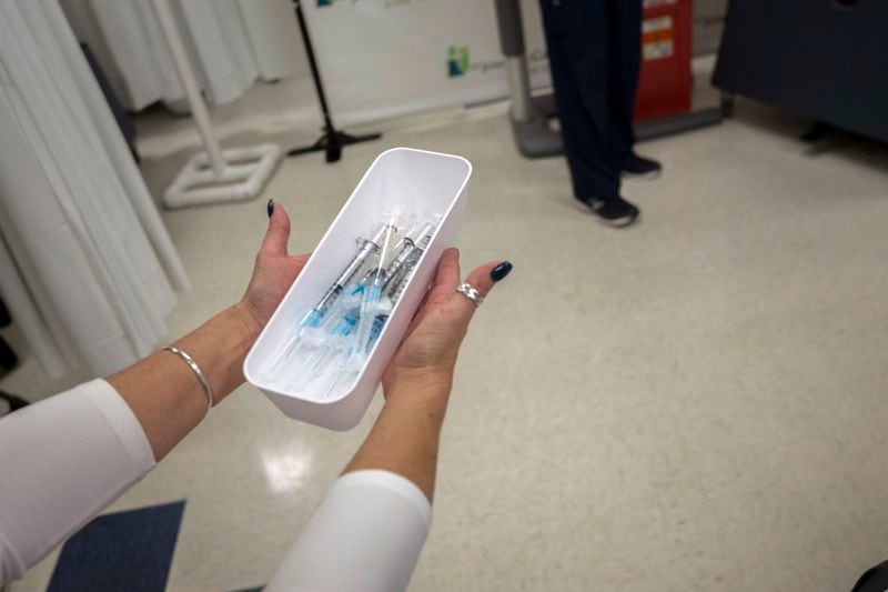 A nurse at St. Joseph's Candler hospital carries the some of the first shots of the Pfizer-BioNTech COVID-19 vaccine to staff for the first inoculations, Tuesday in Savannah. (AJC Photo/Stephen B. Morton)