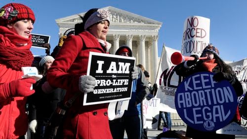 ABORTION RULING ANNIVERSARY--Pro-abortion and anti-abortion protestors rally outside the Supreme Court in Washington, Wednesday, Jan. 22, 2014. Thousands of abortion opponents are facing wind chills in the single digits to rally and march on Capitol Hill to protest legalized abortion, with a signal of support from Pope Francis. (AP Photo/Susan Walsh)