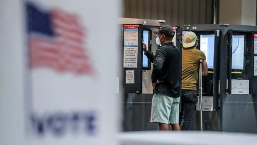 A view of voters Michael Parks and Brett Ringel casting ballots last year at the Antioch Baptist Church in Atlanta. In-person voting is expected to be lower this Election Day with no presidential or midterm election on the ballots. (John Spink / John.Spink@ajc.com)