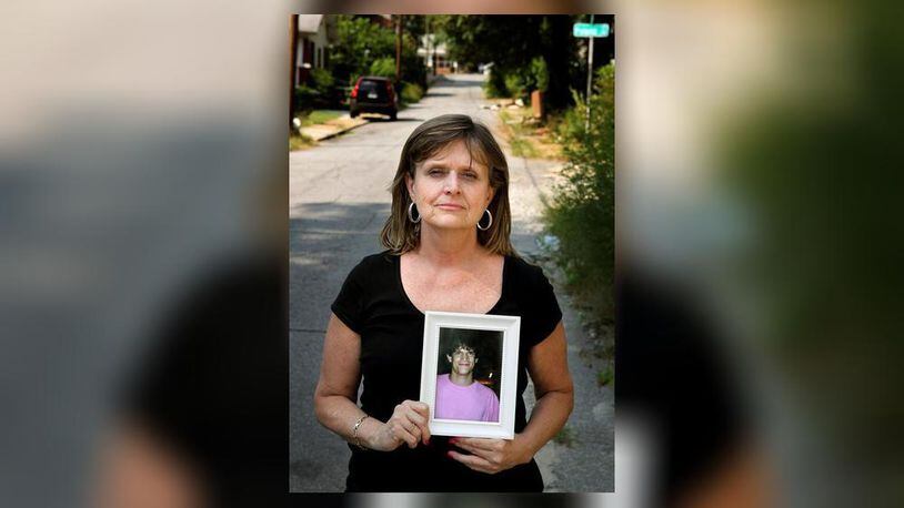 Robin Elliott holds a photograph of her late 21-year-old son, Zack Elliott, who was found dead in his automobile of a drug overdose in 2011. (AJC File Photo)