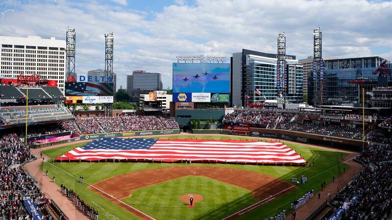 A giant United States flag is stretched across the outfield of Truist Park as military jets fly overhead in observance of Memorial Day before Braves game against the Washington Nationals Monday, May 31, 2021, at Truist Park in Atlanta. (John Bazemore/AP)
