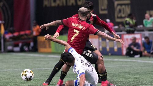 Atlanta United forward Josef Martinez (7), center, Atlanta United midfielder Yamil Asad (11), partially seen, and Montreal Impact defender Victor Cabrera (36) fight over the ball during the second half of a MLS soccer game at Mercedes-Benz Stadium, Sunday, Sept. 24, 2017, in Atlanta.  BRANDEN CAMP/SPECIAL
