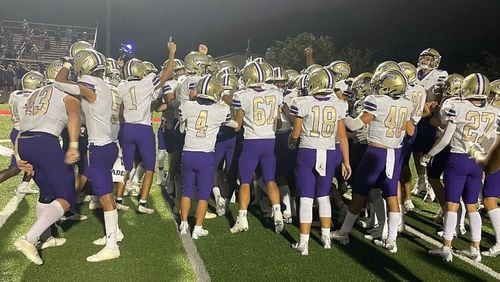 Cartersville players celebrate their 28-20 come-from-behind victory over Allatoona on Sept. 2, 2022, in Acworth.