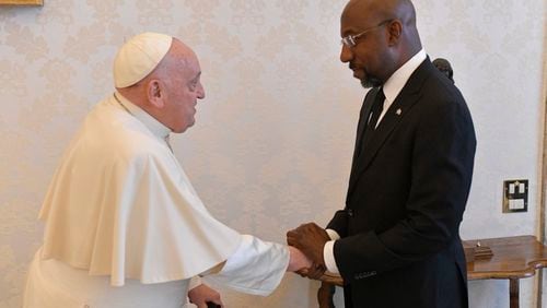 U.S. Sen. Raphael Warnock, an Atlanta Democrat, greets Pope Francis at the Vatican on Saturday, April 20, 2024.