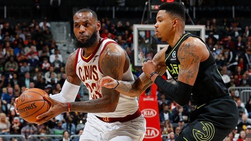 LeBron James  of the Cleveland Cavaliers drives against Kent Bazemore  of the Atlanta Hawks at Philips Arena on February 9, 2018 in Atlanta, Georgia.    (Photo by Kevin C. Cox/Getty Images)