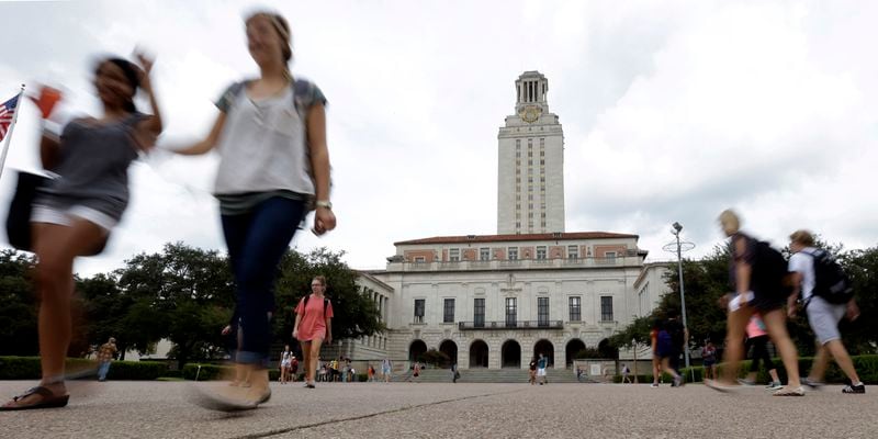 FILE - Students walk through the University of Texas at Austin campus near the school's iconic tower, Sept. 27, 2012, in Austin, Texas. A conservative quest to limit diversity, equity and inclusion initiatives is gaining momentum in state capitals and college governing boards, with officials in about one-third of the states now taking some sort of action against it. (AP Photo/Eric Gay, File)