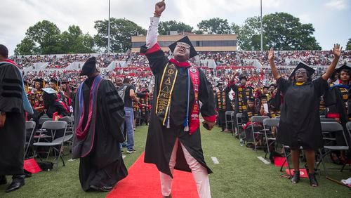 5/20/2019 -- Atlanta, Georgia -- Clark Atlanta University graduate Le'Zaire Reese (center) becomes emotional as a rendition the gospel song, "God is," is performed by The Clark Atlanta University Choirs during the 30th annual commencement ceremony at Panther Stadium in Atlanta, Monday, May 20, 2019. (Alyssa Pointer/alyssa.pointer@ajc.com)