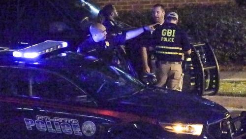 GBI investigators examine the scene where Atlanta Police Officer James Burns shot and killed teenager Deravis Caine Rogers in June 2016. JOHN SPINK /JSPINK@AJC.COM