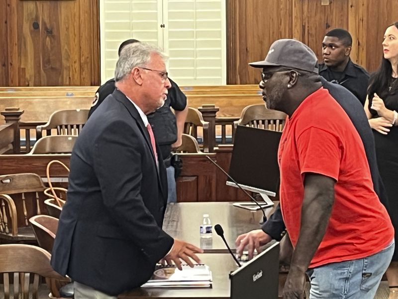 Sapelo Island descendant Maurice Bailey talks with McIntosh County Commission Chairman David Stevens following the County Commission meeting on Tuesday in Darien. Stevens was one of three commissioners who voted for a new law that will allow larger homes to be built on the island, which descendants of Sapelo's Gullah Geechee community fear could destroy their culture. (Richard Burkhart/Savannah Morning News via AP)