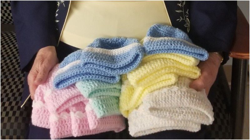 Some of the thousands of knitted caps Betty Banks has made for newborns at Atrium Medical Center.