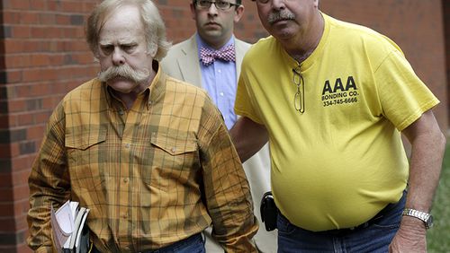 Harvey Updyke, left, leaves the Lee County Justice Center in Opelika, Ala., with his bail bondsman and his attorney on June 10, 2013.