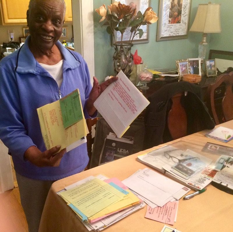Former Decatur Mayor Elizabeth Wilson displays a load of letters and flyers from real estate investors trying to buy her home. Photo by Bill Torpy