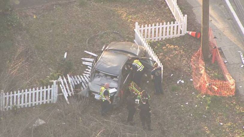 The unmarked Atlanta police car crashed into a fence along Donald Lee Hollowell Parkway. (Credit: NewsChopper 2)