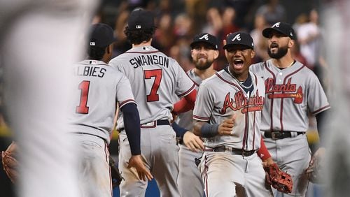 Ronald Acuna Jr. #13 of the Atlanta Braves celebrates with teammates after defeating the Arizona Diamondbacks in the tenth inning of the MLB game at Chase Field on September 8, 2018 in Phoenix, Arizona. The Atlanta Braves won 5-4.  (Photo by Jennifer Stewart/Getty Images)
