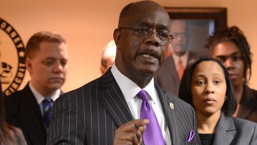 Fulton County District Attorney Paul Howard announces the indictments during a press conference about the Atlanta Public Schools cheating scandal on March 29, 2013. To his immediate right, in the gray suit, is Fani Willis, top prosecutor of the APS case. Howard and Willis are now rivals in a bitter August 2020 runoff election for the position of Fulton DA. (JOHNNY CRAWFORD /  AJC file photo)