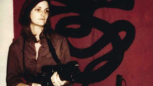 This Polaroid portrait of Patty Hearst, staged and styled by her captors, the so-called Symbionese Liberation Army, has her posed with a machine gun in front of the group’s seven-headed cobra. Photo: courtesy Doubleday