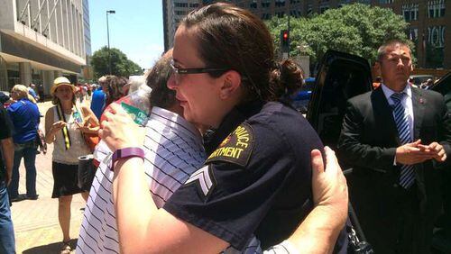 Dallas Police Senior Cpl. Debra Webb hugs a resident after a prayer service in downtown Dallas the day after five officers were shot. Photo: Jennifer Brett, jbrett@ajc.com